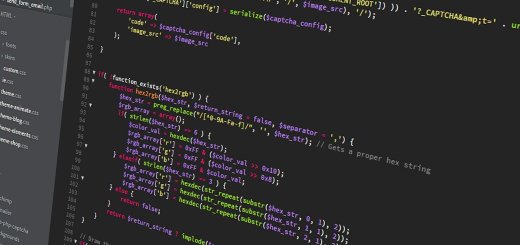 JavaScript code displayed on a dark monitor, showing colorful syntax highlighting.